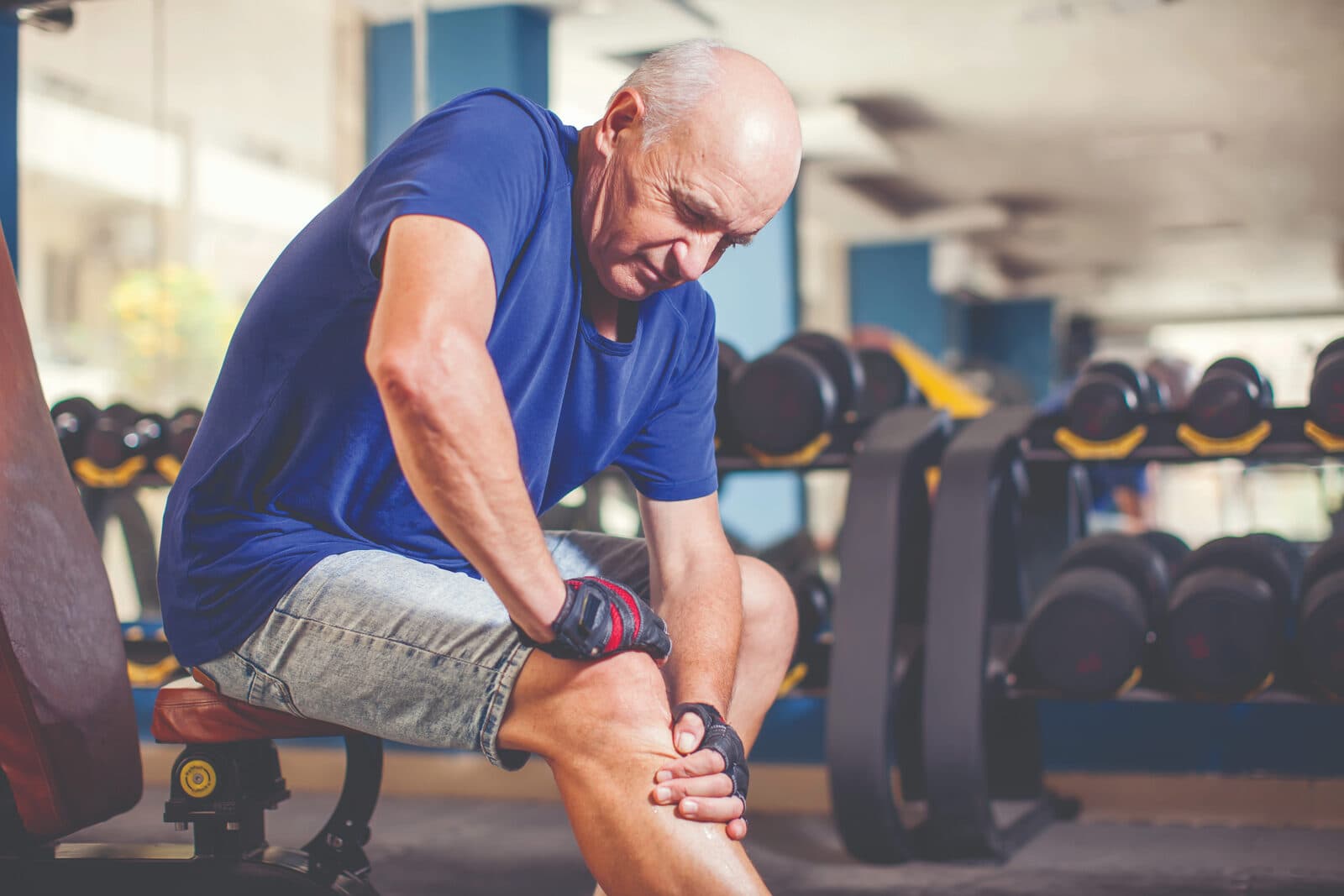 A man doing guided strength work in a gym